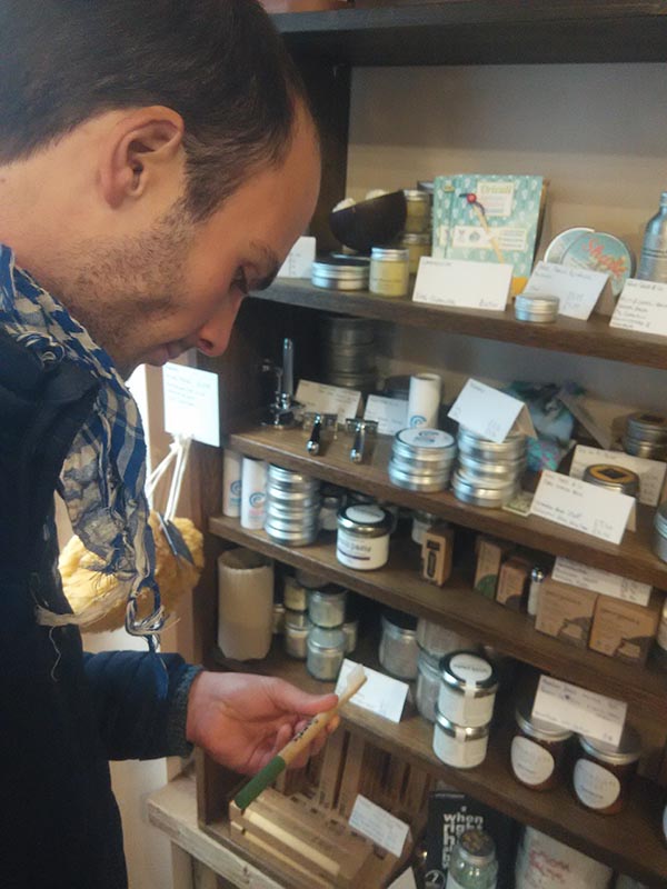 Nico buying a wooden toothbrush in Bridport, United Kingdom
