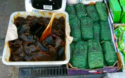 Black soap in bulk and ghassoul clay wrapped in paper spotted on the street in Tangier, Morocco.